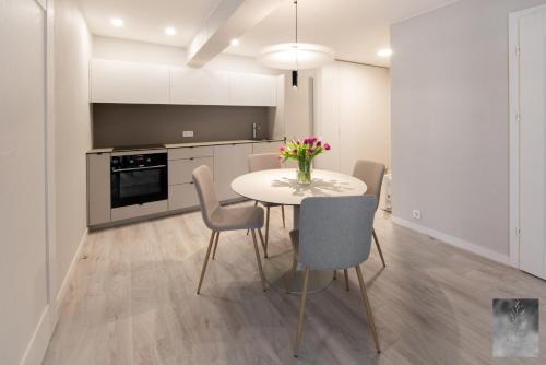 a kitchen with a table and chairs in a room at COME2rest - Smilga in Juodkrantė