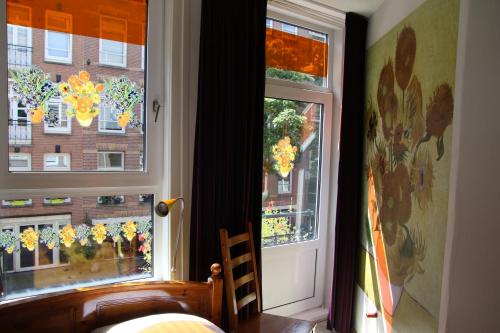 a room with two windows with christmas decorations on them at Bicycle Hotel Amsterdam in Amsterdam