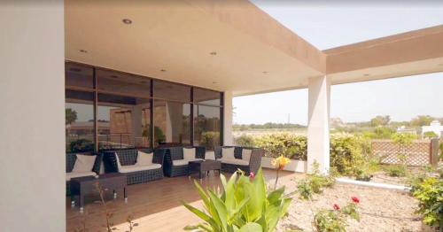 an outdoor patio with couches and pillows at Anavadia Hotel-All Inclusive in Kolimbia