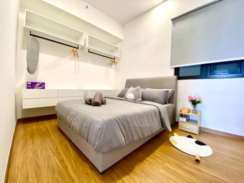 a bedroom with a large bed and a table at Beacon Executive Suite by stayCATion Homestay in George Town