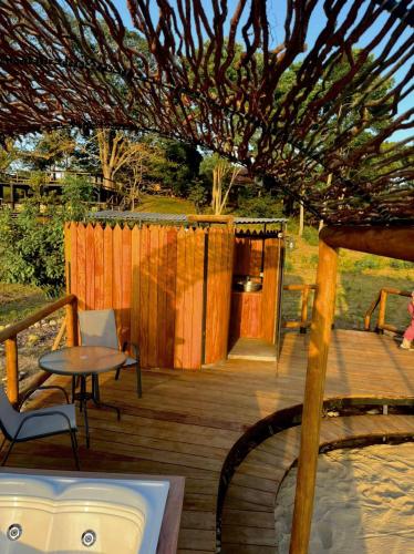 a wooden deck with a table and chairs and a fence at Tiuma Park in Marsella