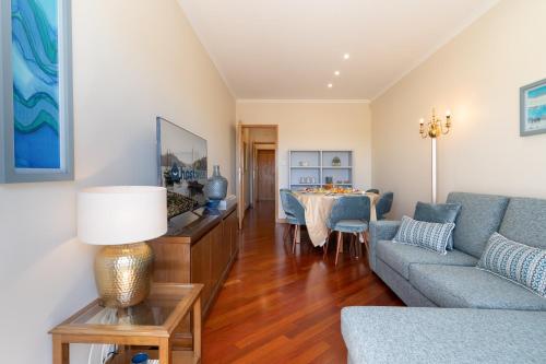 a living room with a couch and a table at Lovely Bright Flat - Instaworthy City View in Vila Nova de Gaia