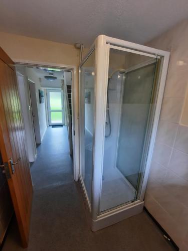 a walk in shower in a room with a hallway at Holiday Cottage 6 in Watermillock