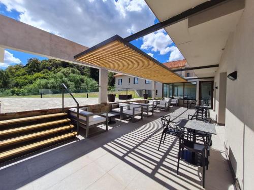 a patio with a bunch of tables and chairs at Hotel Estilo MB - Merlo in El Rincón