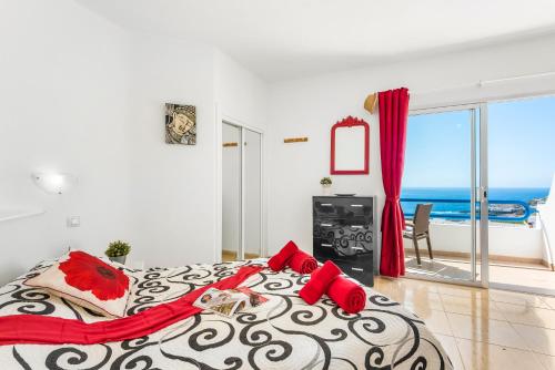 a bedroom with a large bed with a view of the ocean at 1316 Ocean View Studio Paraiso in Playa Paraiso