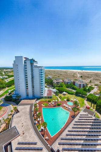 an aerial view of a resort with a swimming pool at The Anchor Troia - River in Troia