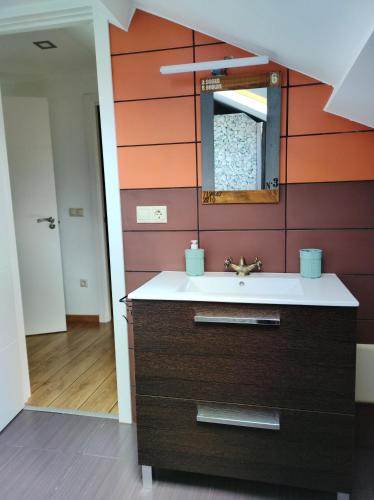 a bathroom with a sink and a mirror at Casa turística a Ardiña in Caldas de Reis