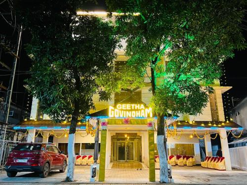 a building with a car parked in front of it at Geetha Govindham in Guruvāyūr