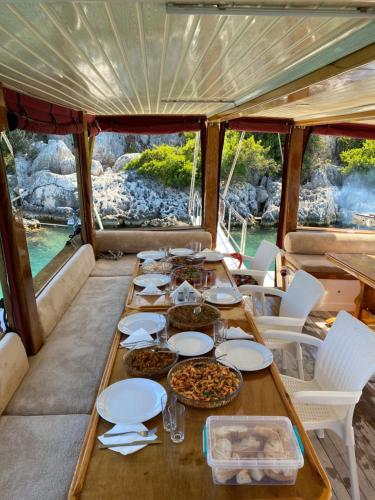 a table with plates of food on a boat at Kekova Private Boat Tour in Demre