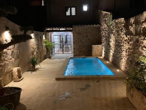 a swimming pool in the middle of a building at Town House Ca Na Mabel in Sa Pobla in Sa Pobla
