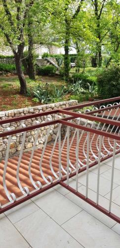 a metal bench sitting on top of a bridge at Rooms and Restaurant Danica in Povile