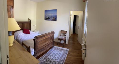 une chambre avec un lit, une table et une chaise dans l'établissement Charmante villa au Cap Ferret à 2 pas du Bassin, à Lège-Cap-Ferret