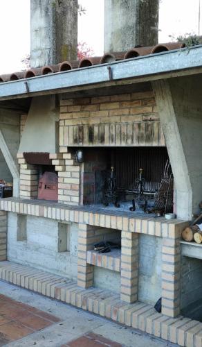 an outdoor brick oven is shown with at Villino Sabina in Civitella del Tronto