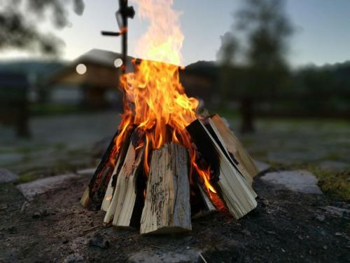 a fire is burning in a pile of wood at Hotel**Pieniny in Niedzica