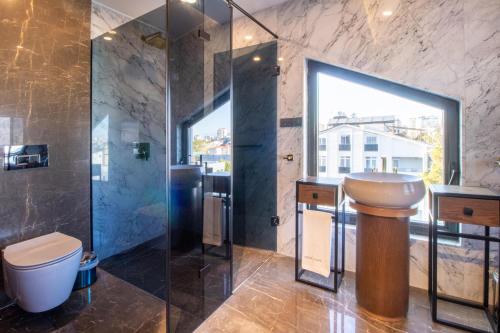 a bathroom with a toilet and a shower and a sink at Espina Hotel in Antalya