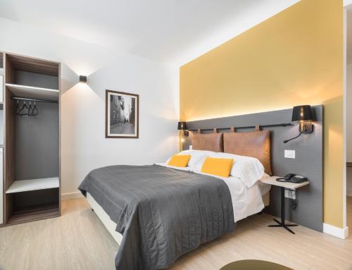 a bedroom with a large bed and a desk at Rivalta Life Style Hotel in Salò