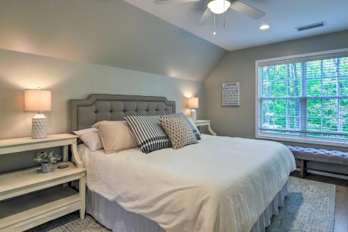 a bedroom with a large bed and a window at Chic Lake Sinclair Retreat with Dock and Hot Tub! in Resseaus Crossroads