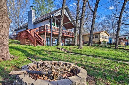 a house with a fire pit in front of it at Fire Pit and Boat Slip Waterfront Grove Getaway in Grove