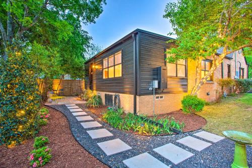 a small black house with a garden at Newly Updated and Charming Azalea District Home in Tyler