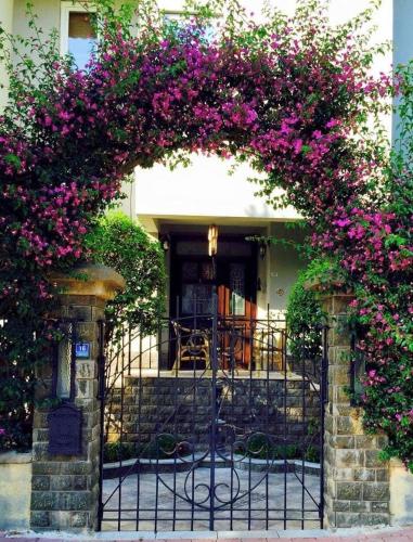 an iron gate with pink flowers on top of it at Villa Sophia Marmaris in Marmaris