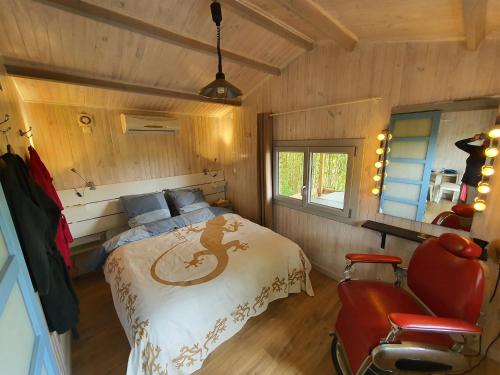 a bedroom with a bed in a room with wooden walls at Adorable chalet avec jacuzzi privatif in Aix-en-Provence