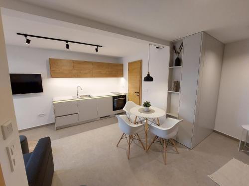 a kitchen with a table and chairs and a sink at Casa Gray in Koper