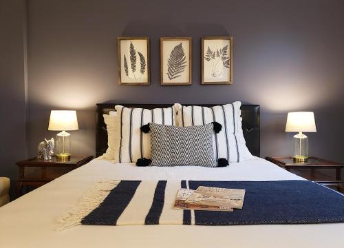 a bedroom with a bed with three pictures on the wall at Little Fig Hotel in Bar Harbor