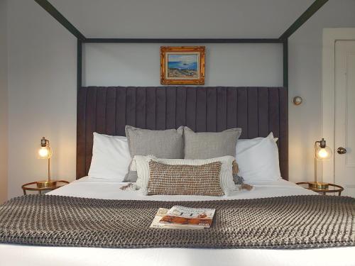a bedroom with a large bed with two lamps at Little Fig Hotel in Bar Harbor