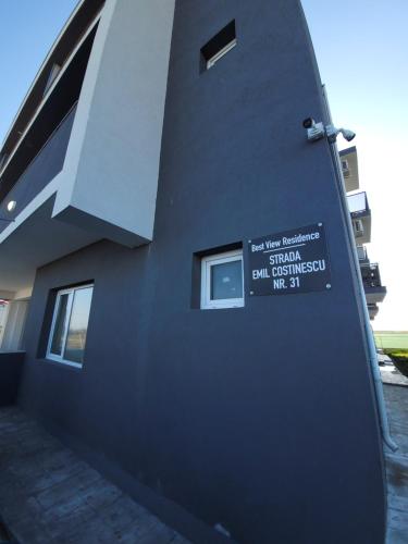 a building with a sign on the side of it at Best View Residence in Costinesti