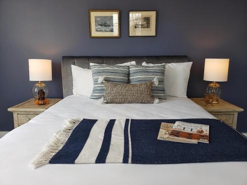a bedroom with a bed with two lamps on tables at Little Fig Hotel in Bar Harbor