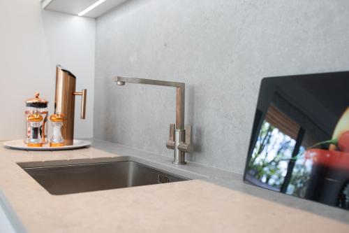 a kitchen counter with a sink and a tv at Springfield Four in Harrogate