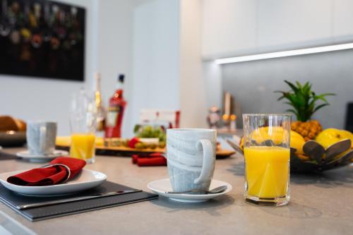 a table with a glass of orange juice and a cup of coffee at Springfield Four in Harrogate
