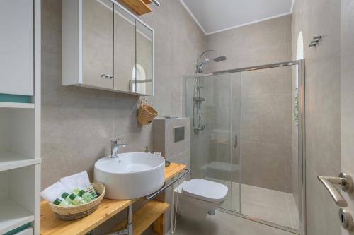y baño con aseo, lavabo y ducha. en Niva Kamiros Apartments, en Kamiros