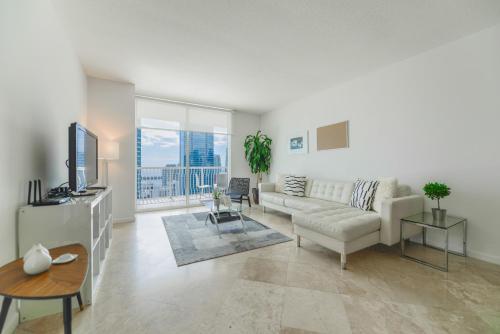 a living room with a couch and a tv at Amazing apartment in the Heart of Brickell in Miami