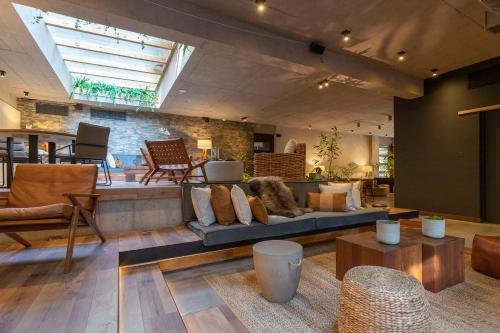 a large living room with a couch and tables at The Place in Santiago