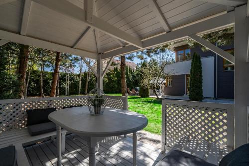 a patio with a table and an umbrella at Serenity Prague Villa with garden jacuzzi in Prague