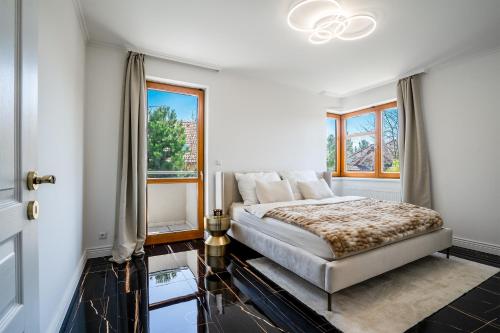 a bedroom with a bed and a window at Serenity Prague Villa with garden jacuzzi in Prague