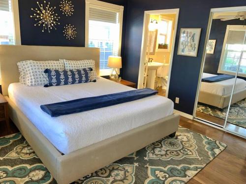 a bedroom with a large bed with a mirror at The Comforts' Inn: Mountain Escape in Mountainaire