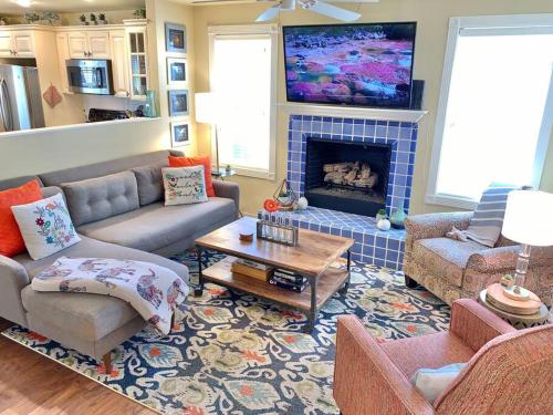 a living room with a couch and a fireplace at The Comforts' Inn: Mountain Escape in Mountainaire
