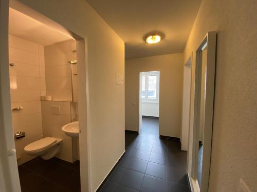 a bathroom with a toilet and a sink at Galaxy Apartments Lucerne in Luzern