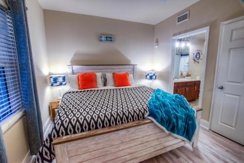 a bedroom with a bed with orange and blue pillows at Laketown Wharf Resort 1036 By Aneliya in Panama City Beach