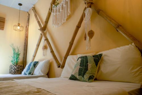 a bedroom with a bed with a bunch of chandeliers at Casa Wabi Sabi in Pedasí Town
