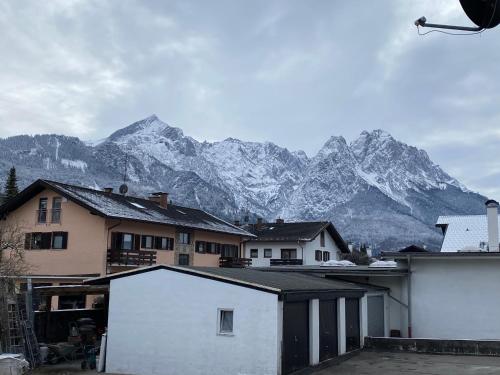 a group of houses with mountains in the background at Ferienhaus Butterfly 2 in Garmisch-Partenkirchen
