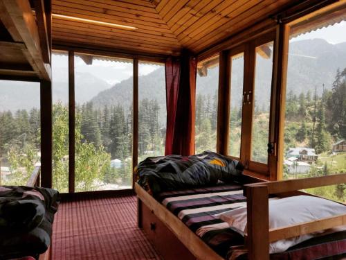 a bedroom with a view of a mountain at Mud Hostel Shangarh in Shangarh