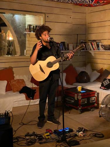 a man playing a guitar in a room at Rue du Château in Tarascon