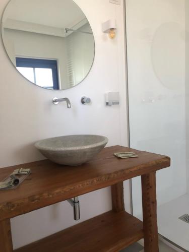 a bathroom with a sink and a mirror on a table at Relais Masseria Villa Cenci in Cisternino