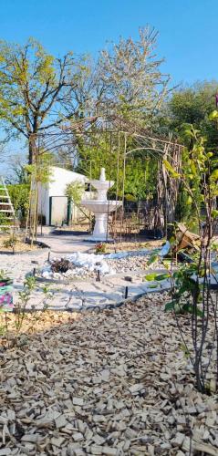 a statue in the middle of a stone yard at La Plumeria in Baincthun