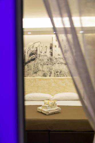 a view of a bed through a window at Rooms Dream Tropea in Tropea