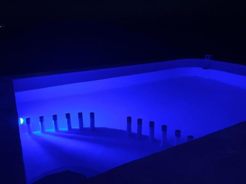 a dark room with a tub with blue lighting at La Casa Amarilla Frente al Mar in Chelem
