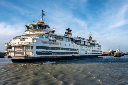 a large cruise ship sitting in the water at Appartement Duinzee Texel in De Koog